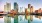 a city skyline with a body of water in front of it