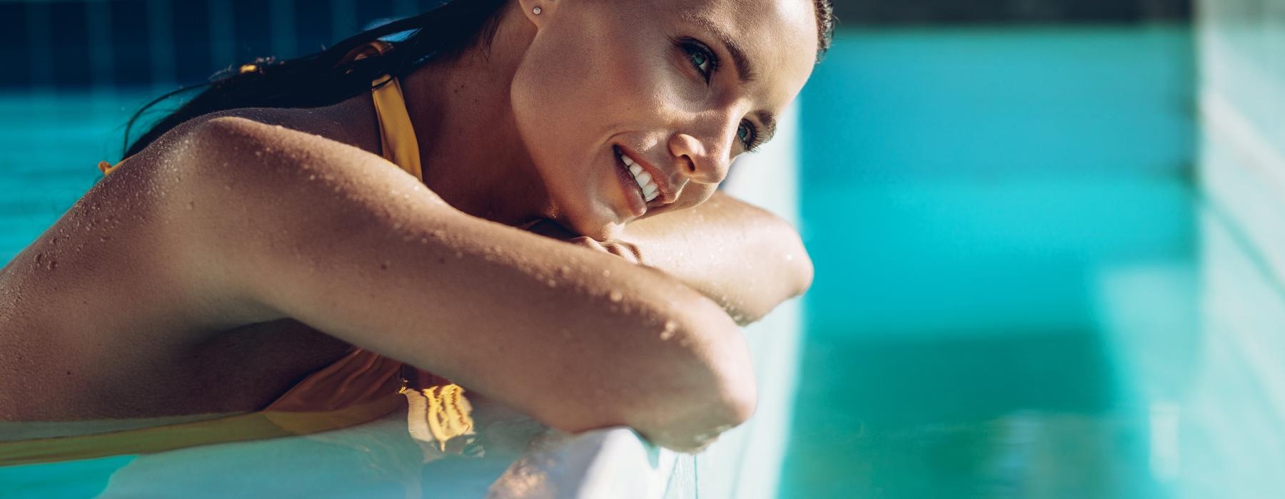 woman rests on pool's ledge