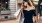 woman walks in city with hands full of shopping bags