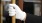 white gloved hand opens a door