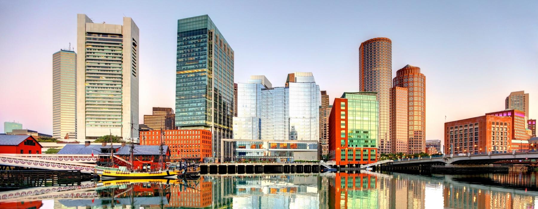 a city skyline with a body of water in front of it